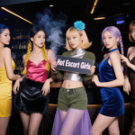 Five women in stylish dresses pose for a photo. "Hot Escort Girls" sign is held in the center.