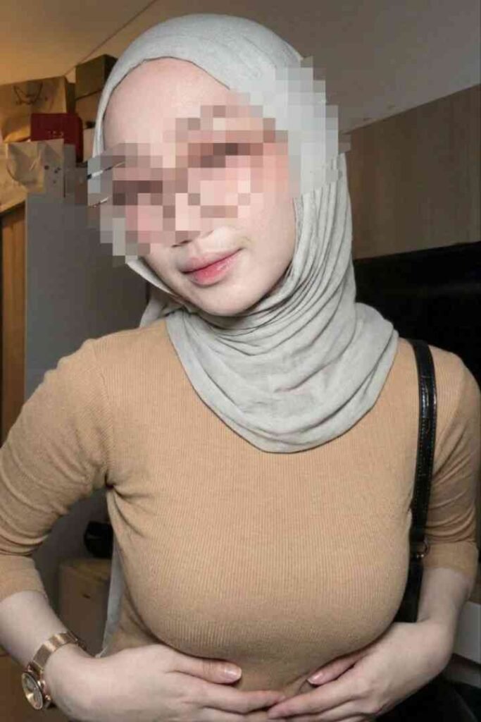 Young Malay woman in hijab and tan top, Kesya.